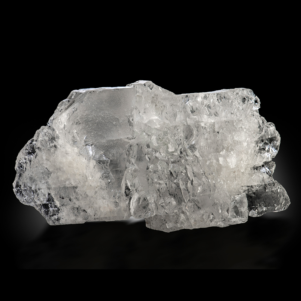 Petalite (Castorite) – Large Gem-Clear Crystalline Mass with Etched Faces and Included Green Tourmaline