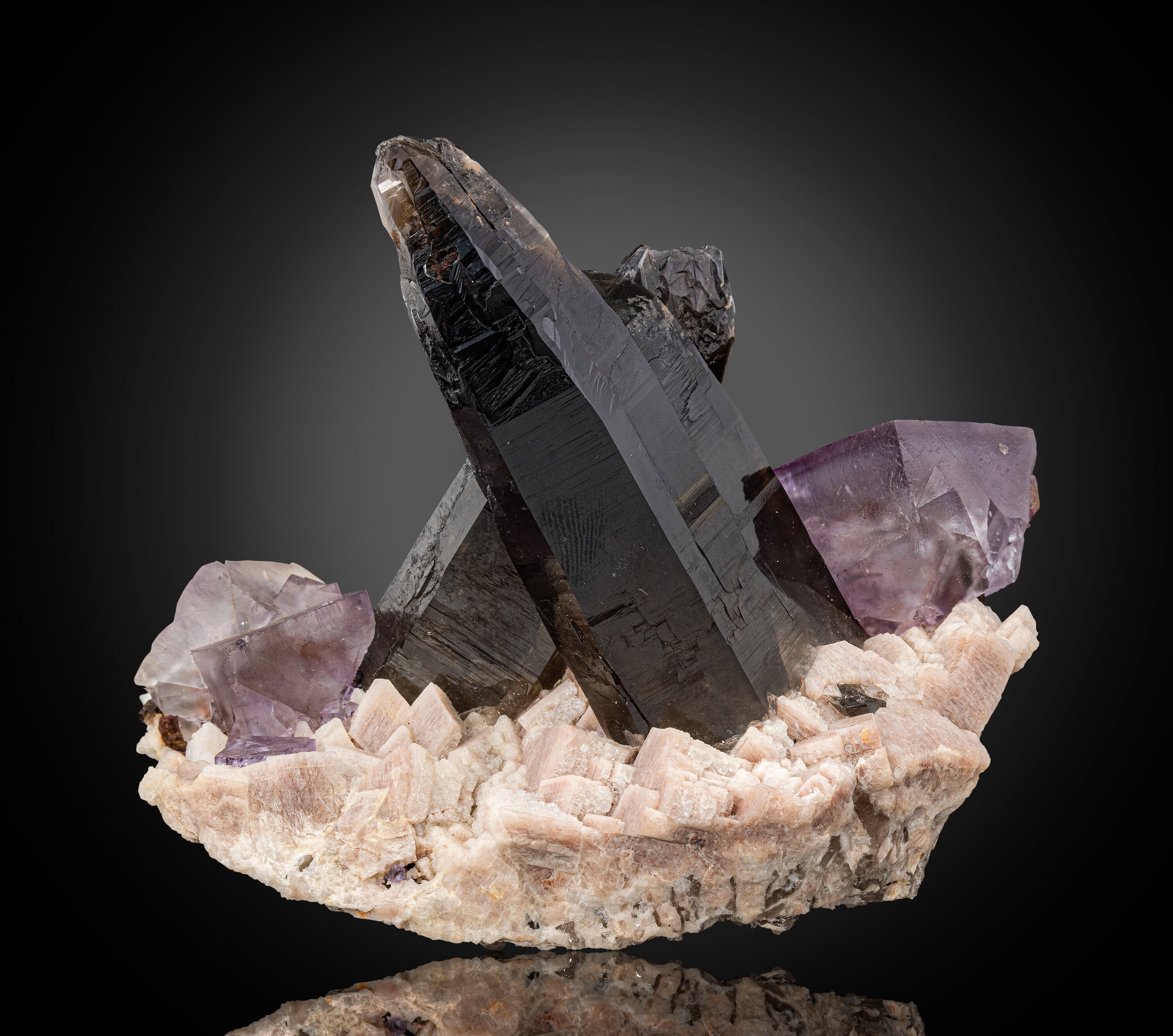 Twinned Fluorite and Smoky Quartz on Feldspar